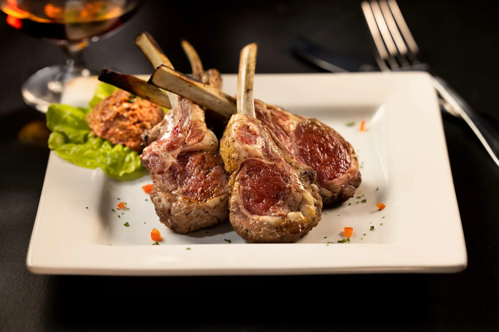 Lamb lollipops plated at Alluvia, the restaurant inside The Cheetah