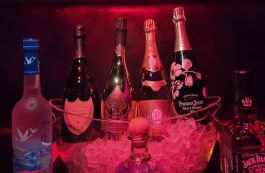 Champagne and vodka bottles on ice for bottle service at Palomino