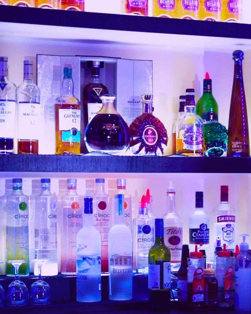 Backlit liquor bottle display at Bella's Cabaret