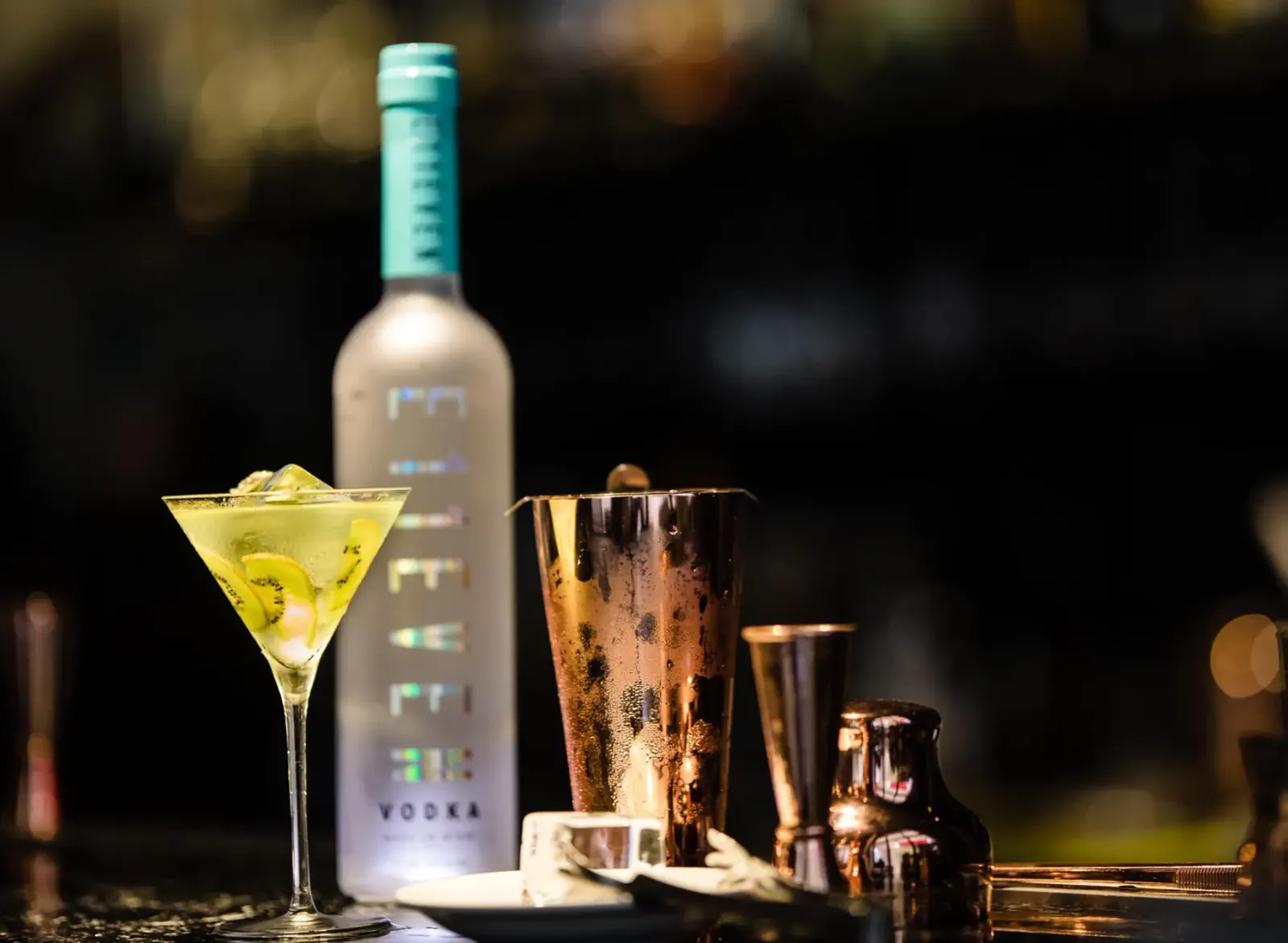 E11EVEN Vodka bottle and martini on a bar top