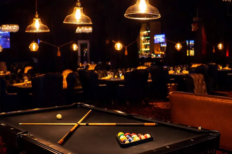 Rick's Steakhouse lounge inside Scarlett's Cabaret with pool table and pendant lights
