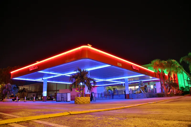 Tootsie's Cabaret entrance canopy lit in red and blue neon at night